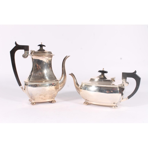 60 - Geo.V silver four piece tea and coffee set, the tea pot and coffee pot with angular ebonized handles... 