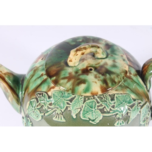 311 - Victorian Dunmore pottery Majolica teapot, of mottled green and brown glaze around an ivy framed car... 