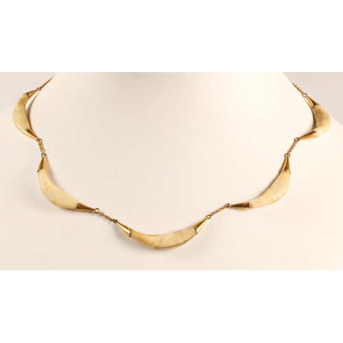 51 - Yellow metal necklet with fox tooth links....