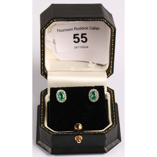 55 - Pair of 18ct gold stud diamond cluster earrings set with emerald oval stones...