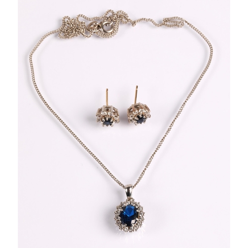 57 - Silver pendant necklace set with blue stone surrounded by white stones and a pair of matching earrin... 