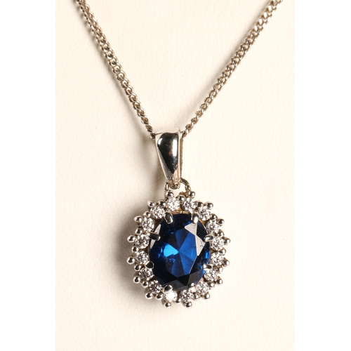 57 - Silver pendant necklace set with blue stone surrounded by white stones and a pair of matching earrin... 