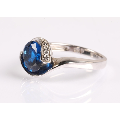 61 - Silver ring set with a large blue gem flanked by small white gems, Size P, 3.8g