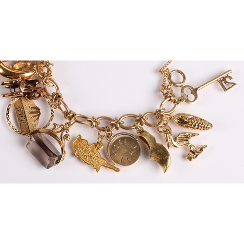 64 - 9ct gold charm bracelet with twenty charms, mainly gold, 41g gross