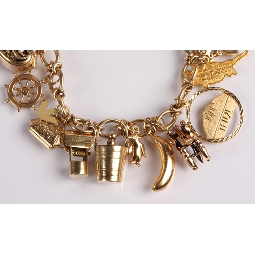 64 - 9ct gold charm bracelet with twenty charms, mainly gold, 41g gross