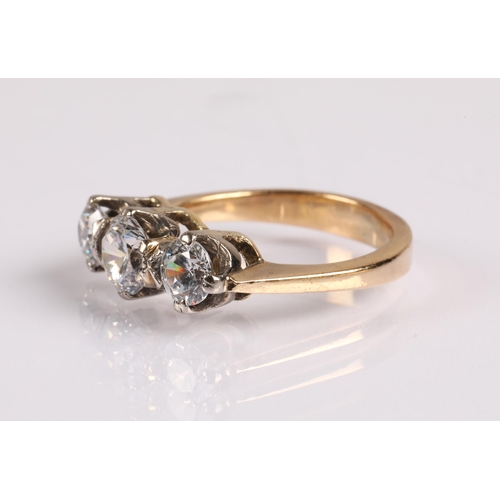 68 - Unmarked yellow metal three stone dress ring, the white stones do not test as diamonds, ring size J,... 