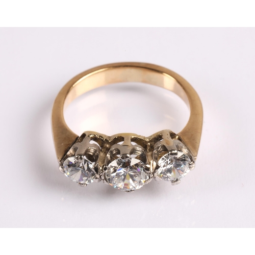 68 - Unmarked yellow metal three stone dress ring, the white stones do not test as diamonds, ring size J,... 