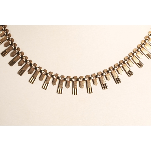 69 - 9ct gold fringe necklace in the 1970's Brutaliist style, 16g.