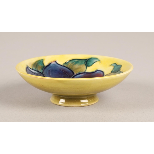 9 - Moorcroft pin dish, yellow with blue flower 11cm, paper label to base...