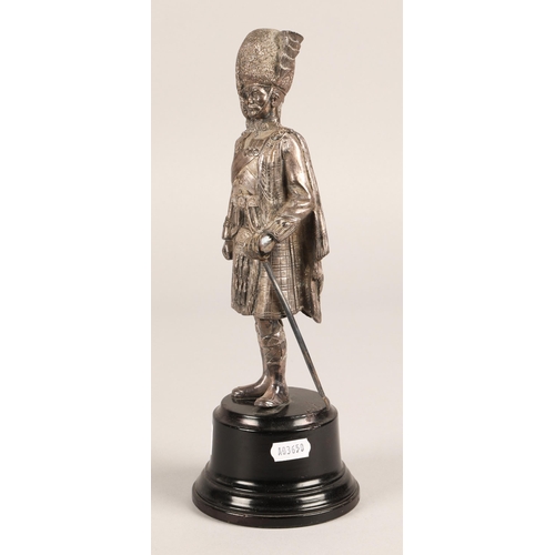 26 - White metal model of a Queens own Cameron Highlanders Officer on turned ebonised base, 30cm...