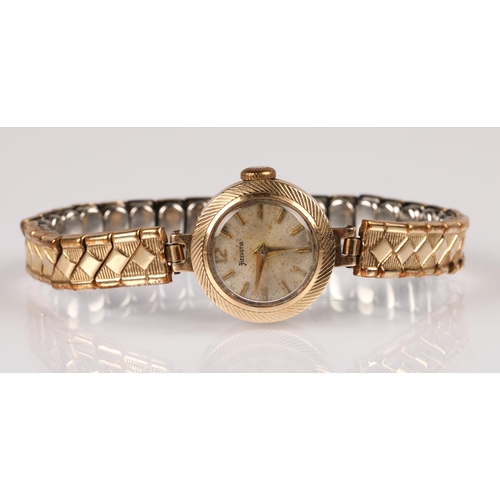 84 - Ladies 9ct gold cased Helvetia wristwatch on plated expanding bracelet, 12g gross.