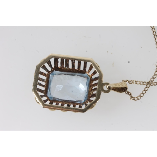 119 - 14ct gold mounted Brutalist style pendant set with faceted aquamarine coloured blue stone, the hoop ... 