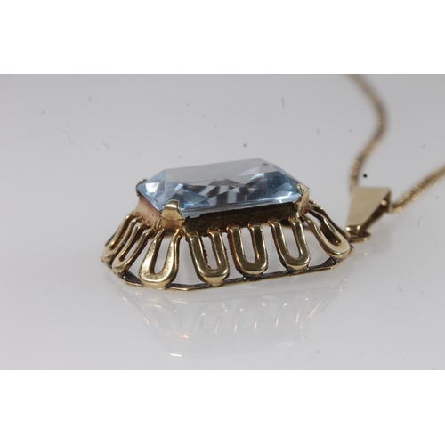 119 - 14ct gold mounted Brutalist style pendant set with faceted aquamarine coloured blue stone, the hoop ... 