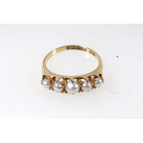 129 - Early 20thC 18ct gold and pearl ring, the graduating pearls in a shared claw setting on a plain tape... 