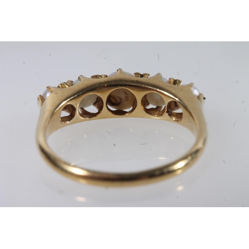 129 - Early 20thC 18ct gold and pearl ring, the graduating pearls in a shared claw setting on a plain tape... 