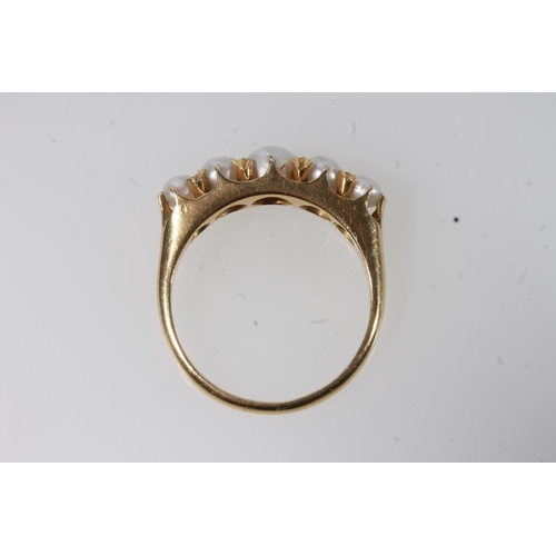 129 - Early 20thC 18ct gold and pearl ring, the graduating pearls in a shared claw setting on a plain tape... 