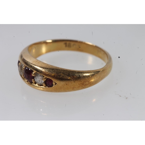 132 - Early 20thC 18ct gold ruby and diamond ring, the graduating stones in a clawed boat setting on a tap... 