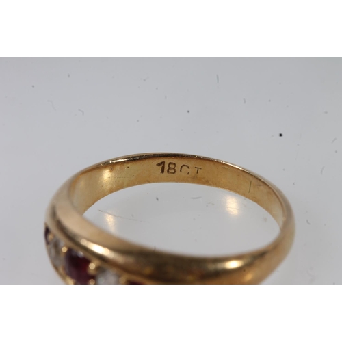 132 - Early 20thC 18ct gold ruby and diamond ring, the graduating stones in a clawed boat setting on a tap... 