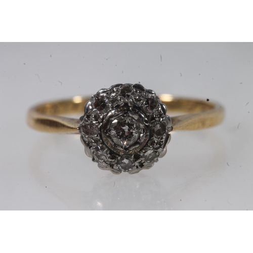 135 - 18ct gold diamond cluster ring, the principal round cut diamond bezel set within a halo of prong set... 