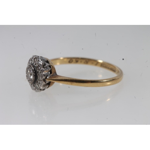 135 - 18ct gold diamond cluster ring, the principal round cut diamond bezel set within a halo of prong set... 