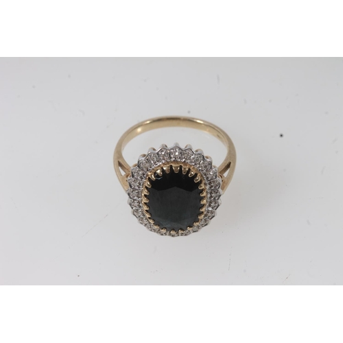 138 - 9ct gold sapphire and diamond cluster ring, the large oval cut dark sapphire within a halo of small ... 