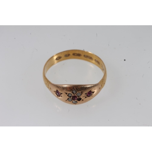 140 - Victorian 22ct gold ruby and white stone ring, the small stones prong set in a flower head form, siz... 