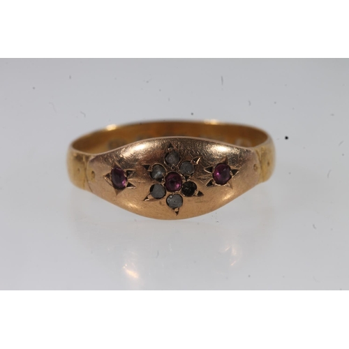 140 - Victorian 22ct gold ruby and white stone ring, the small stones prong set in a flower head form, siz... 