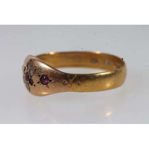 140 - Victorian 22ct gold ruby and white stone ring, the small stones prong set in a flower head form, siz... 