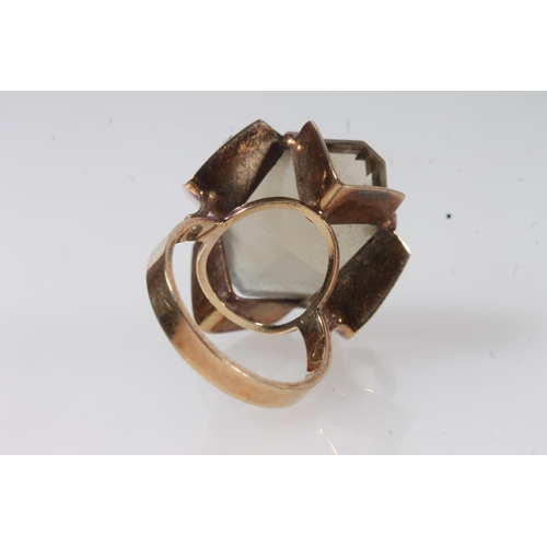 141 - 9ct gold and yellow stone modernist ring, the large citrine coloured stone on a geometric pierced mo... 