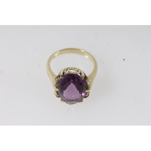 144 - 14ct gold amethyst ring, the large oval cut amethyst on a pronged rope twist filigree setting on a p... 