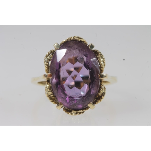 144 - 14ct gold amethyst ring, the large oval cut amethyst on a pronged rope twist filigree setting on a p... 