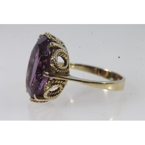 144 - 14ct gold amethyst ring, the large oval cut amethyst on a pronged rope twist filigree setting on a p... 