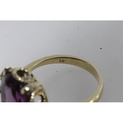 144 - 14ct gold amethyst ring, the large oval cut amethyst on a pronged rope twist filigree setting on a p... 