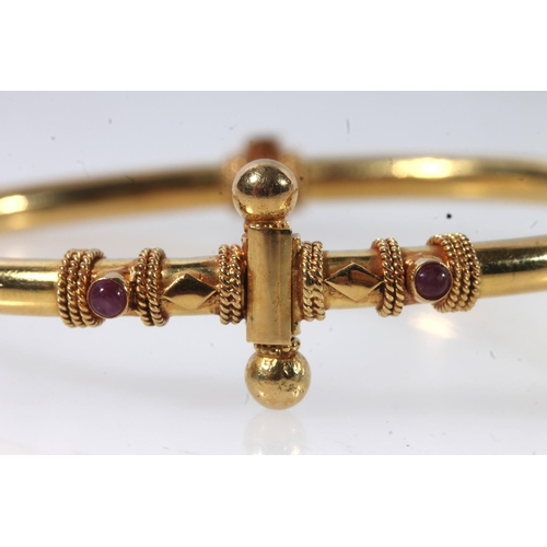 159 - Indian yellow metal bangle set with two cabochon rubies.