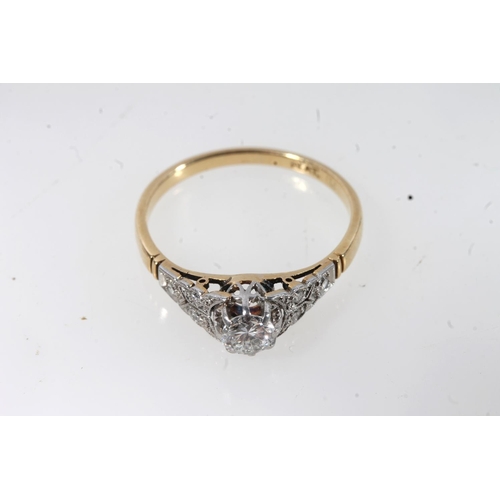 177 - 18ct gold and platinum solitaire diamond ring, the round cut brilliant in a claw setting, flanked by... 