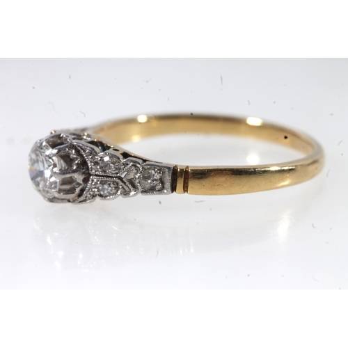 177 - 18ct gold and platinum solitaire diamond ring, the round cut brilliant in a claw setting, flanked by... 