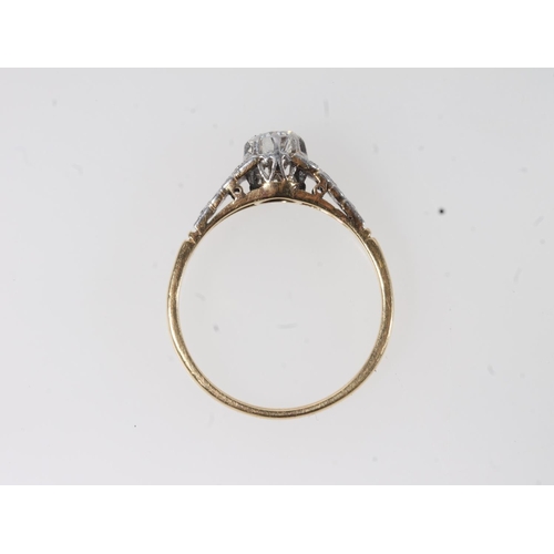 177 - 18ct gold and platinum solitaire diamond ring, the round cut brilliant in a claw setting, flanked by... 