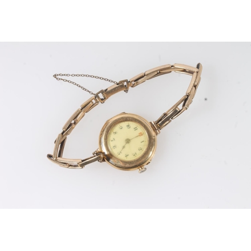 193 - Ladies 18ct gold cased wristwatch, the dial with black arabic numerals, on 12ct rolled gold bracelet... 