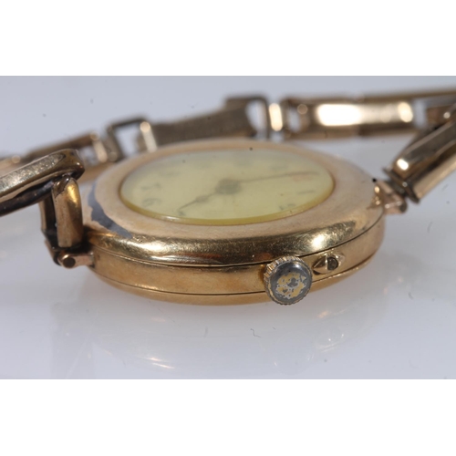 193 - Ladies 18ct gold cased wristwatch, the dial with black arabic numerals, on 12ct rolled gold bracelet... 