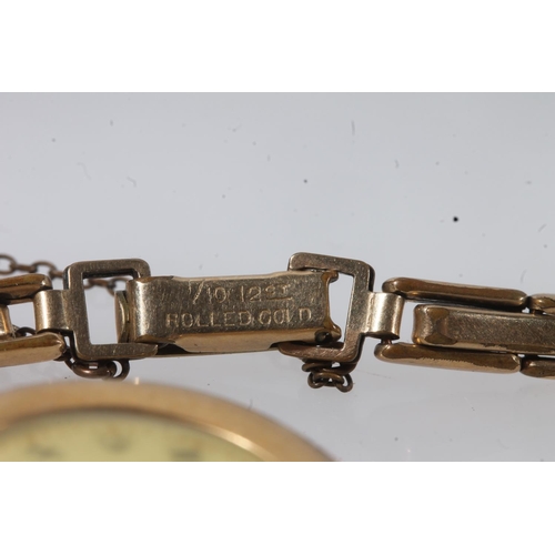 193 - Ladies 18ct gold cased wristwatch, the dial with black arabic numerals, on 12ct rolled gold bracelet... 