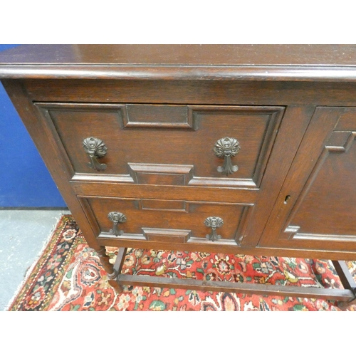 504 - Modern oak dresser on twist supports, the cupboard base flanked by two drawers. Height 173cm, Width ... 