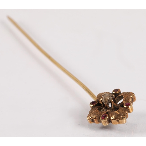 100A - Stick pin set with a seed pearl, head marked 9ct, another yellow metal set with a diamond and four p... 