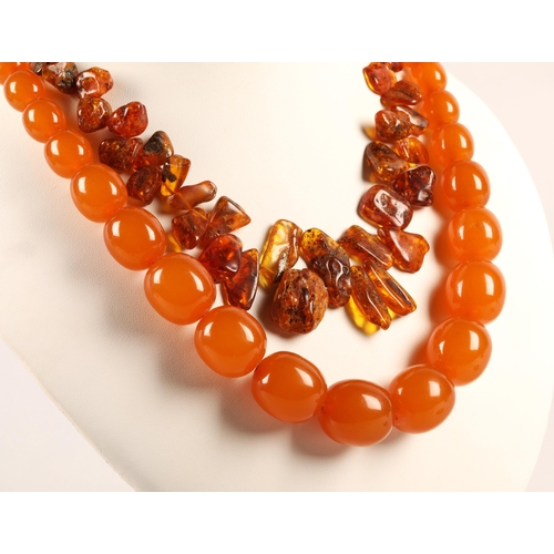 106A - Raw amber bead necklace and an amber colour bakelite/plastic necklace