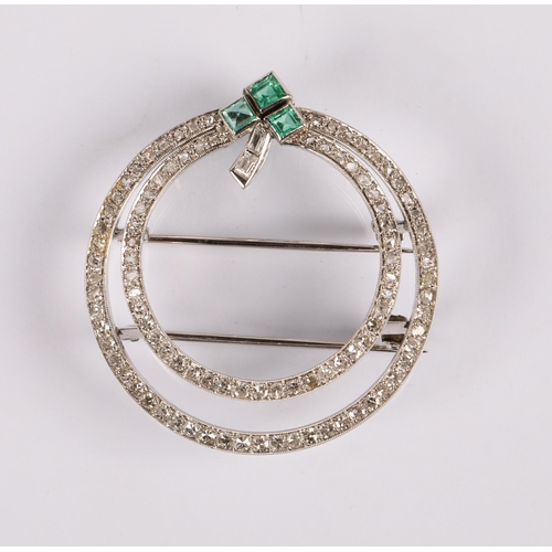 55A - Art Deco style circular white metal brooch set with diamonds and a trio emeralds in a clover design,...