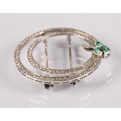 55A - Art Deco style circular white metal brooch set with diamonds and a trio emeralds in a clover design,...