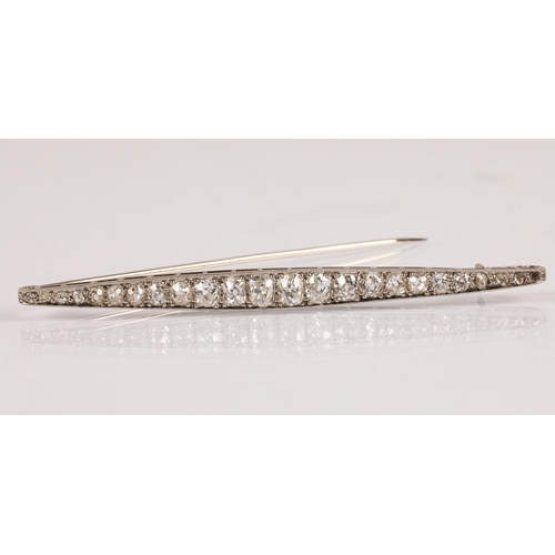 57A - White metal bar brooch set with a graduated  old cut diamonds, 8cm, 7.4g