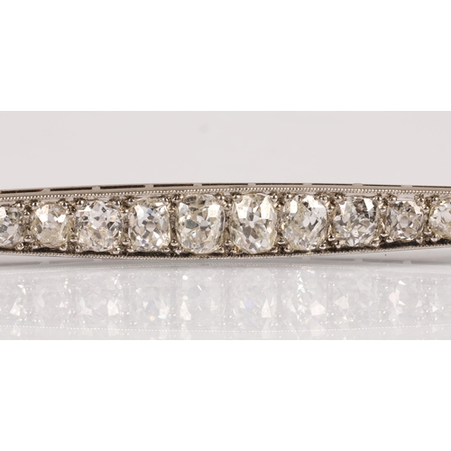 57A - White metal bar brooch set with a graduated  old cut diamonds, 8cm, 7.4g