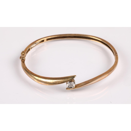 116 - 9ct gold bangle set with a white stone, 10.8g