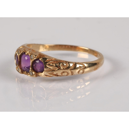 123 - 9ct gold ring set with three purple stones and diamond chips, 1.9g, ring size L