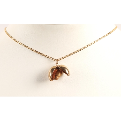 152 - 9ct gold novelty egg charm which opens to reveal a bird, on a 9ct gold chain, 8.7g